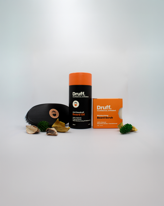 Druff beard care products including a beard oil, soap and boar beard brush on a light gray background